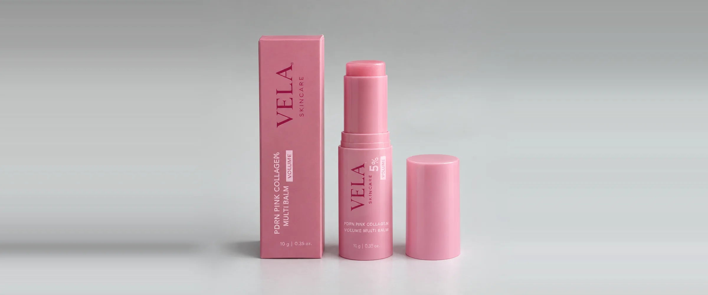 VELA PDRN Pink Collagen Volume Multi Balm in its pink box, cap off beside it